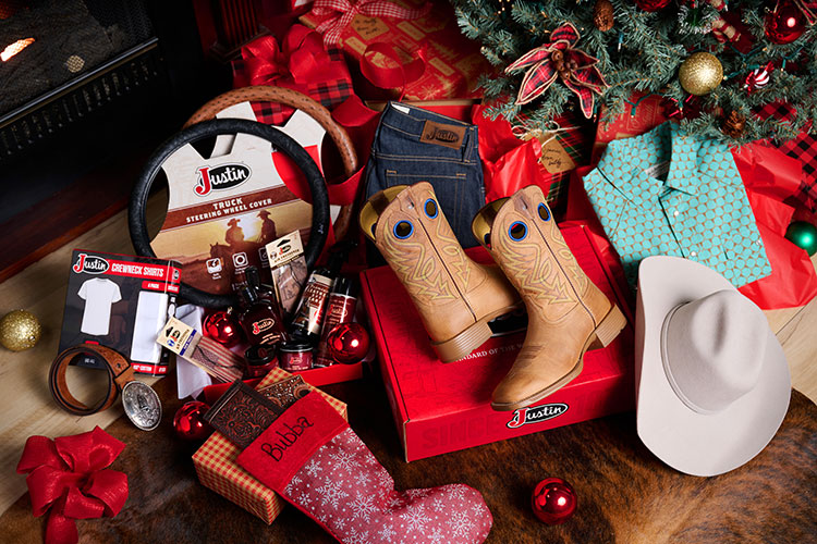 HJ Justin & Son Snap Shirt in Green Cow Hive and classic straight leg mens jeans in unwashed blue with Pickett 11” Men’s Wide Square Toe in Tan under a Christmas tree.